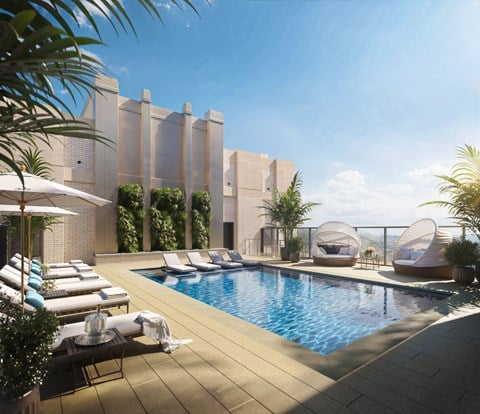 A modern pool area with lounge chairs and umbrellas.
