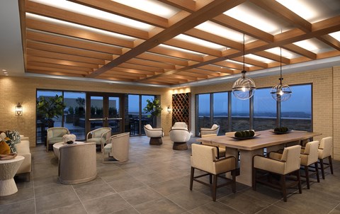 A modern dining room with a large table and chairs.