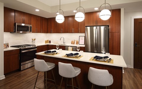A modern kitchen with a white countertop and brown cabinets.