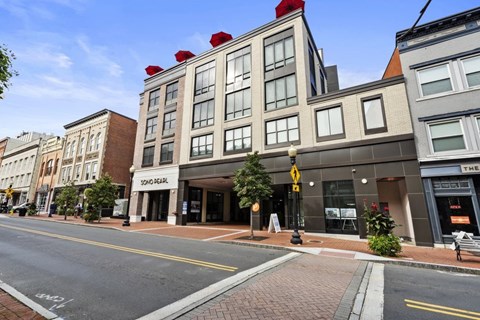 A street view of a city with a building that has a sign that says "SONG HEAR".