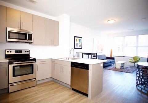 A modern kitchen with a stove, oven, and microwave.