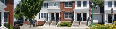 A white house with a black door and windows.