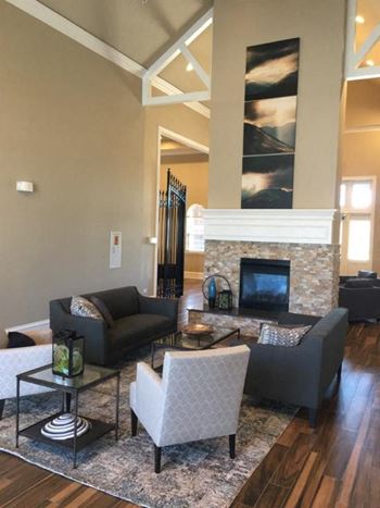 a living room with couches and chairs and a fireplace at Remington Apartment Homes, Romeoville, Illinois