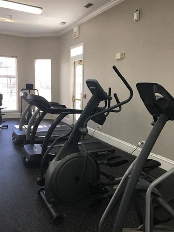 a gym with some exercise equipment in it at Remington Apartment Homes, Romeoville, IL, 60446