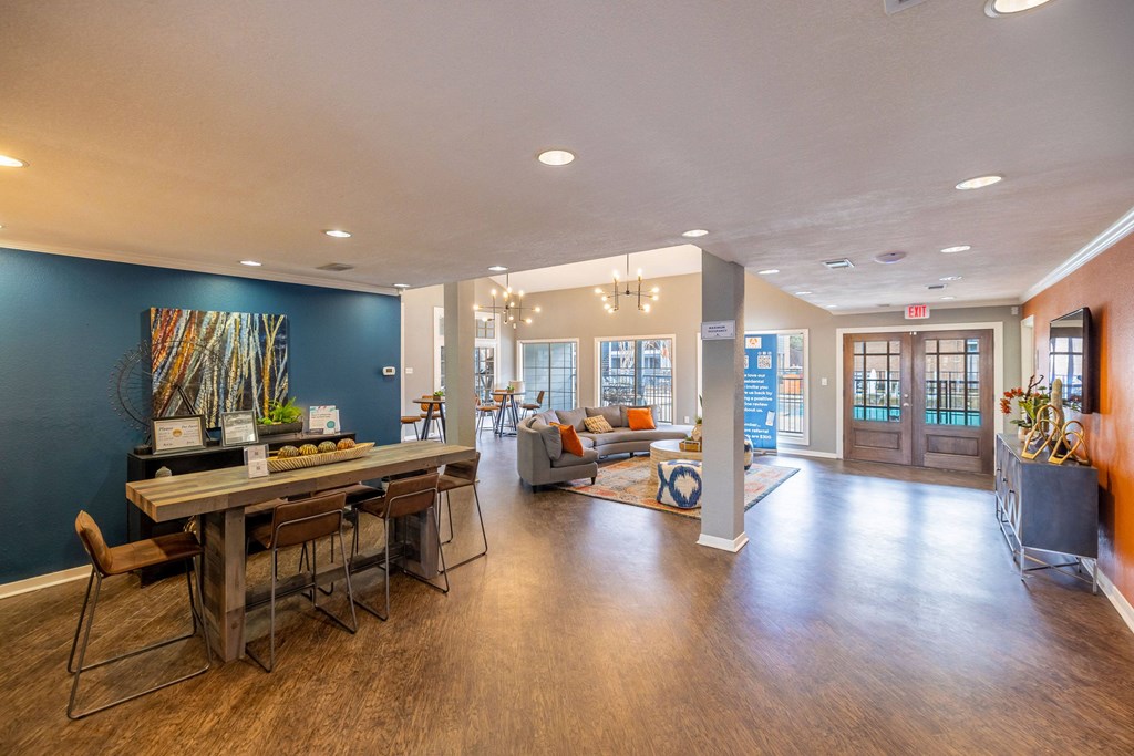 A dining room with a long table and chairs.