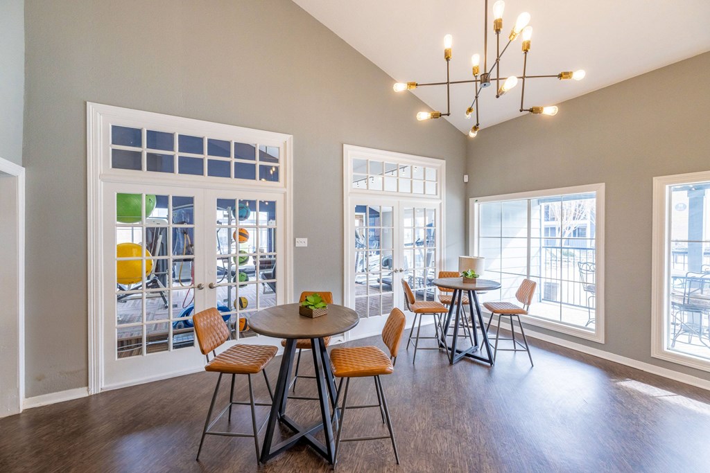 A dining room with a round table and chairs.