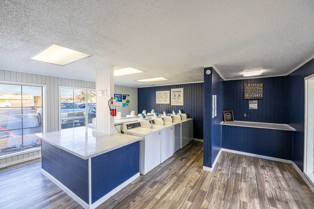 A reception area with a white counter and blue walls.