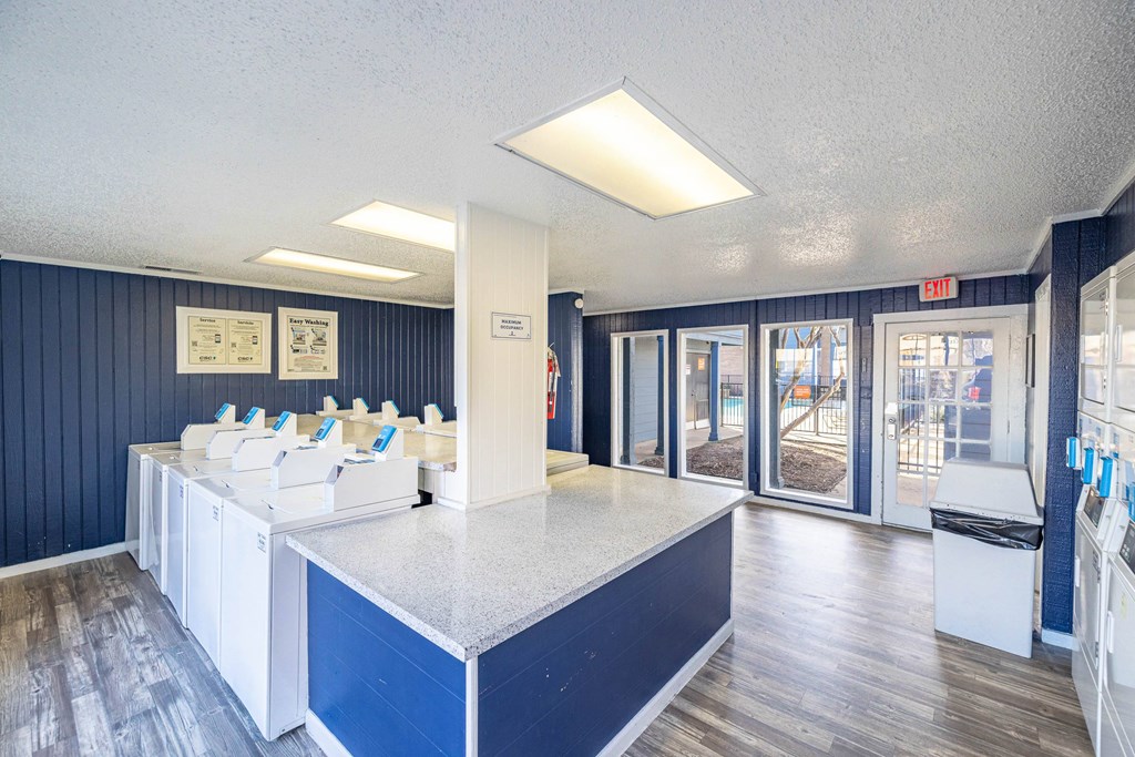 A reception area with a counter and chairs.