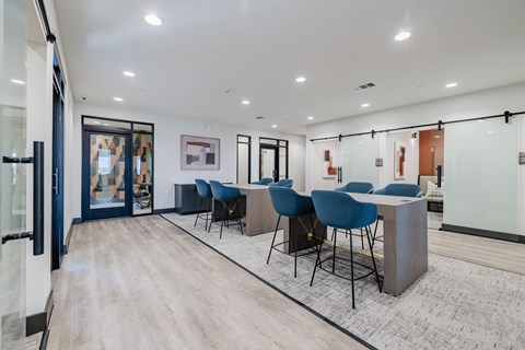A conference room with blue chairs and a white table.