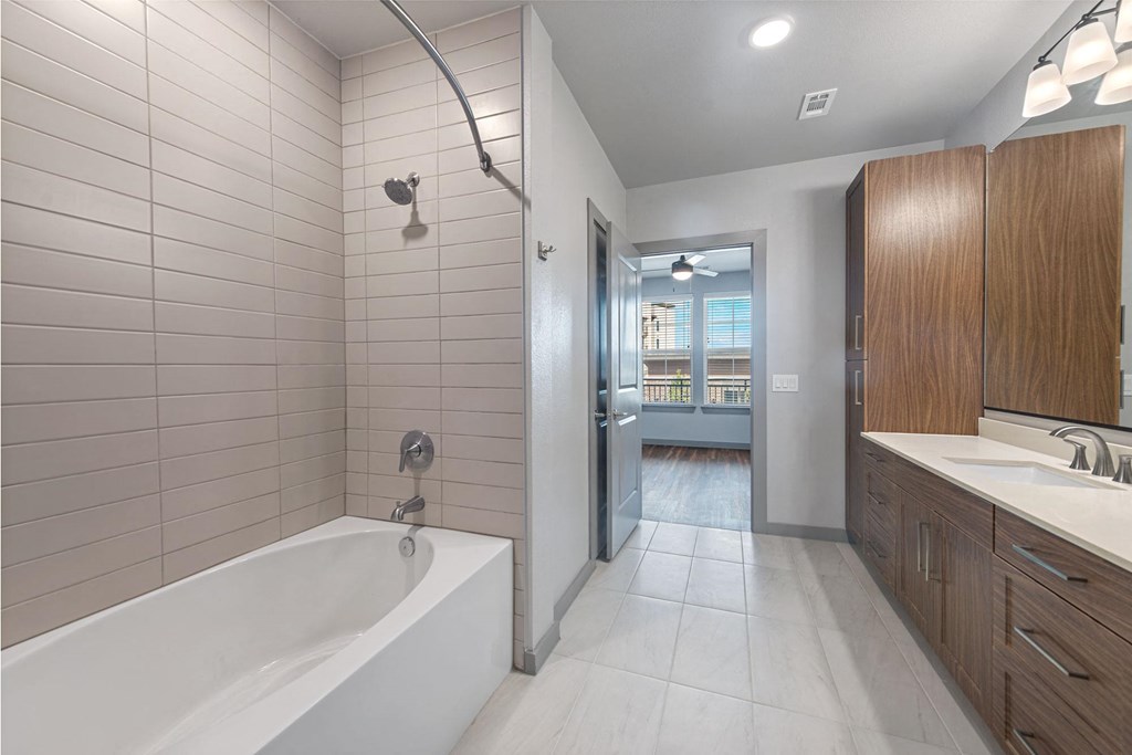 a bathroom with a tub and a sink