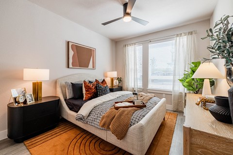 a bedroom with a bed and a ceiling fan