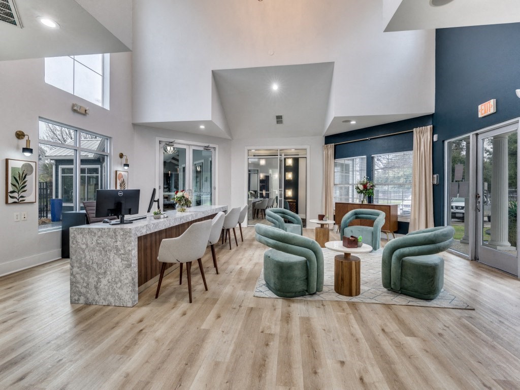 a living room with a bar and chairs and a kitchen a living room with a bar and chairs and a kitchen  at Vibe on Riverside, Austin, TX, 78741
