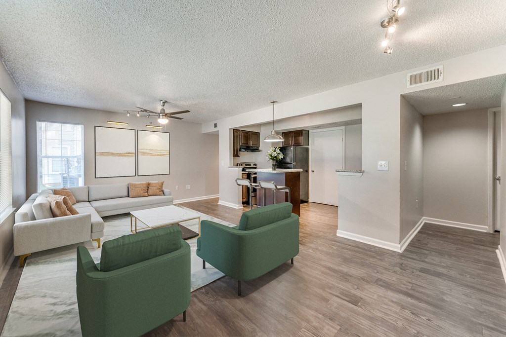 a living room with couches and chairs and a dining room with a kitchen a living room with couches and chairs and a dining room with a kitchen  at Vibe on Riverside, Austin, TX