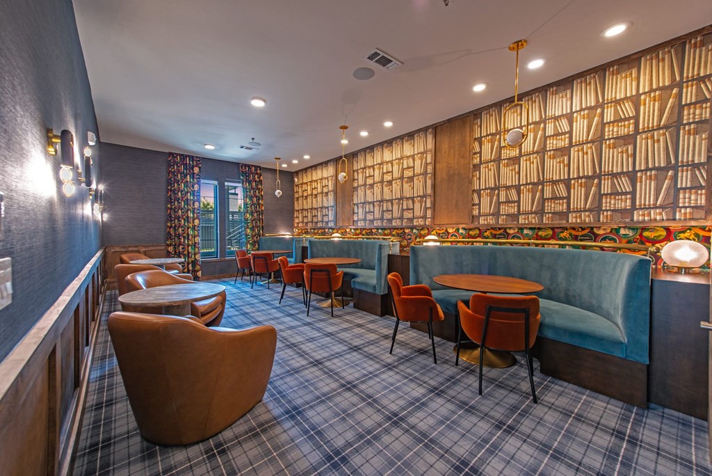 a restaurant with blue booths and chairs and a tartan rug