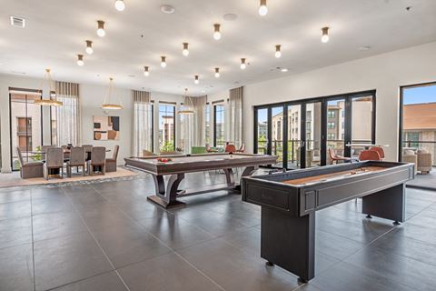 a games room with two pool tables and a ping pong table