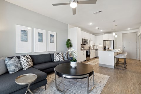 A living room with a grey couch and a coffee table.