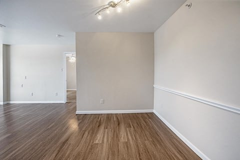 a bedroom with hardwood floors and white walls a bedroom with hardwood floors and white walls at Collective on Riverside, Austin, Texas