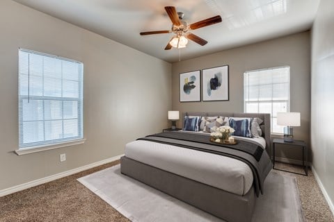 a bedroom with a large bed and a ceiling fan  at Valor at Harlingen, Harlingen, Texas