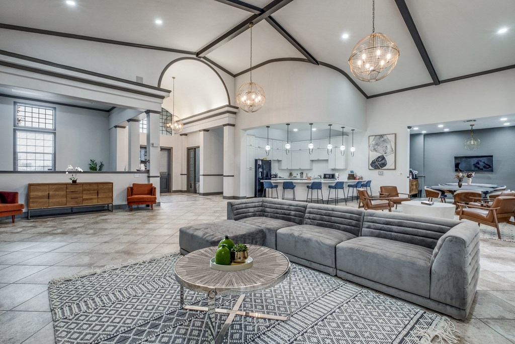 a living room with couches and a table  at Valor at Harlingen, Harlingen, TX