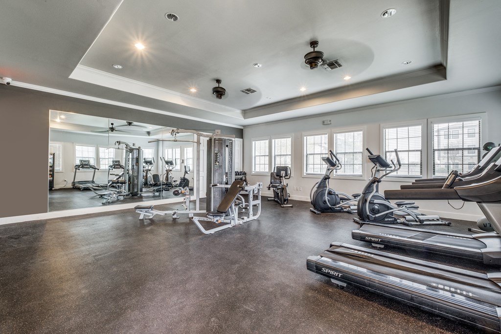 the gym has treadmills and other exercise equipment and windows  at Valor at Harlingen, Harlingen, TX, 78552
