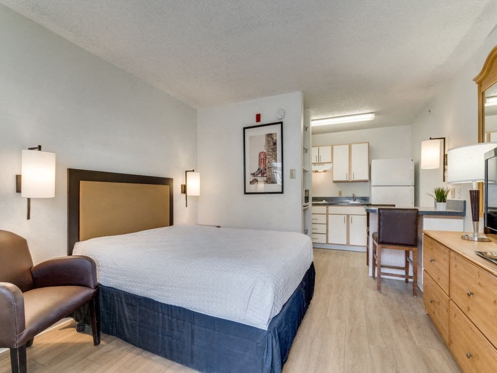a hotel room with a bed and a kitchen  at Waterford Studios, Texas
