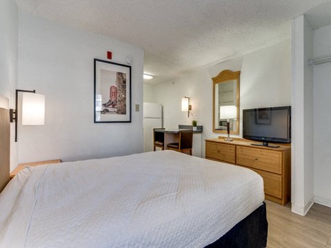 a bedroom with a bed and a tv in a hotel room  at Waterford Studios, Austin, Texas