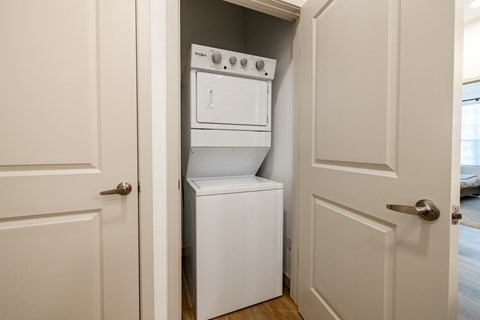 A white dishwasher and oven are built into a wall in a kitchen.