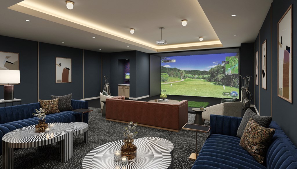 a lobby with couches and tables and a large screen tv