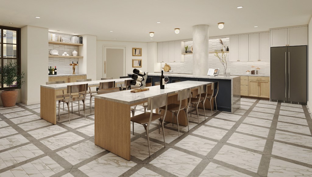 a large kitchen with a long island with chairs and a counter