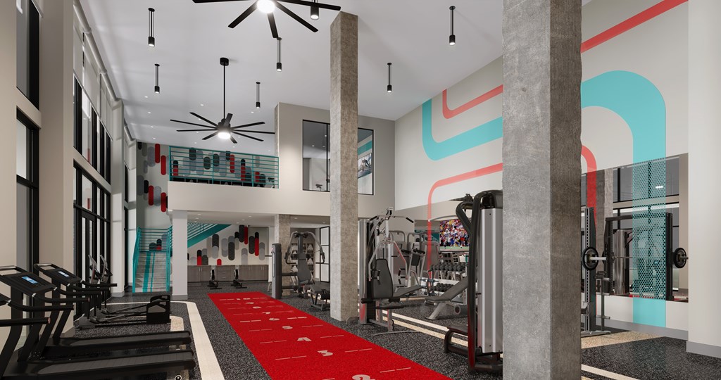 A gym with a red carpet and various exercise equipment.