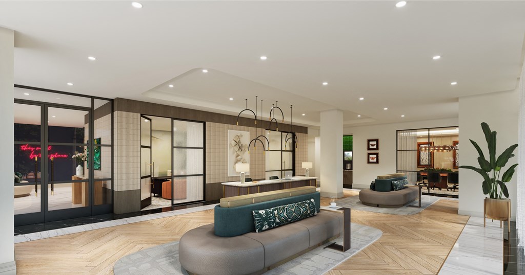 A modern living room with a large sofa and a glass wall.