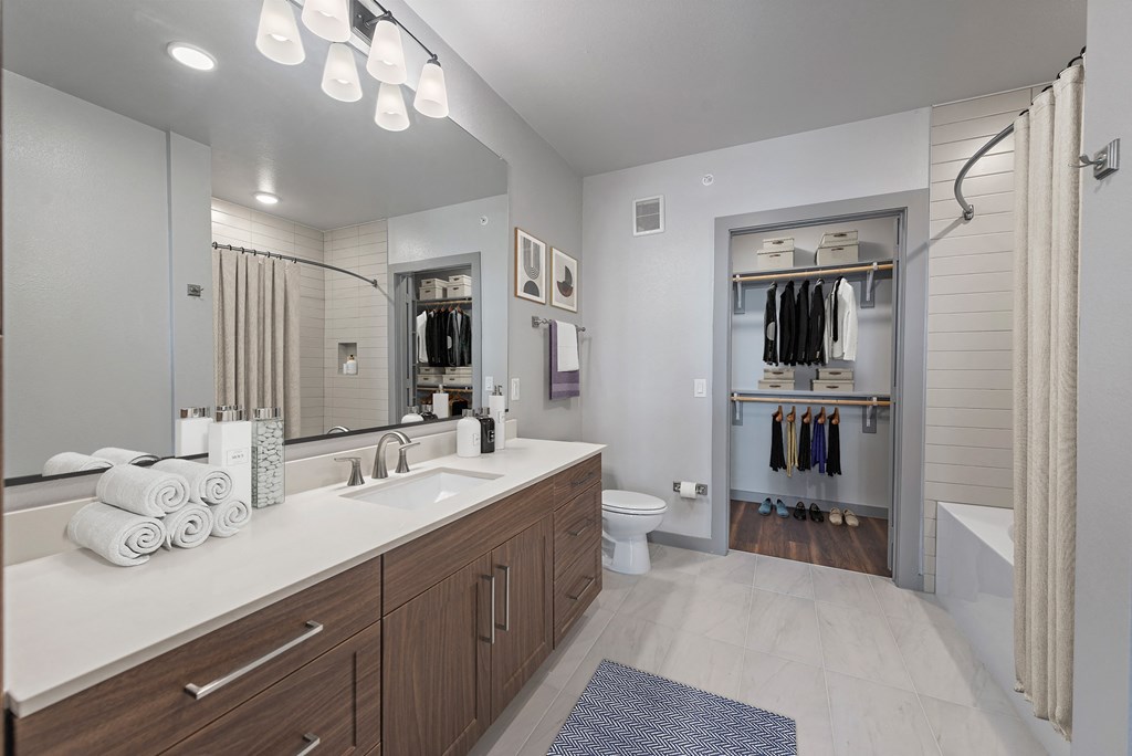 a bathroom with a large mirror and a shower with a curtain