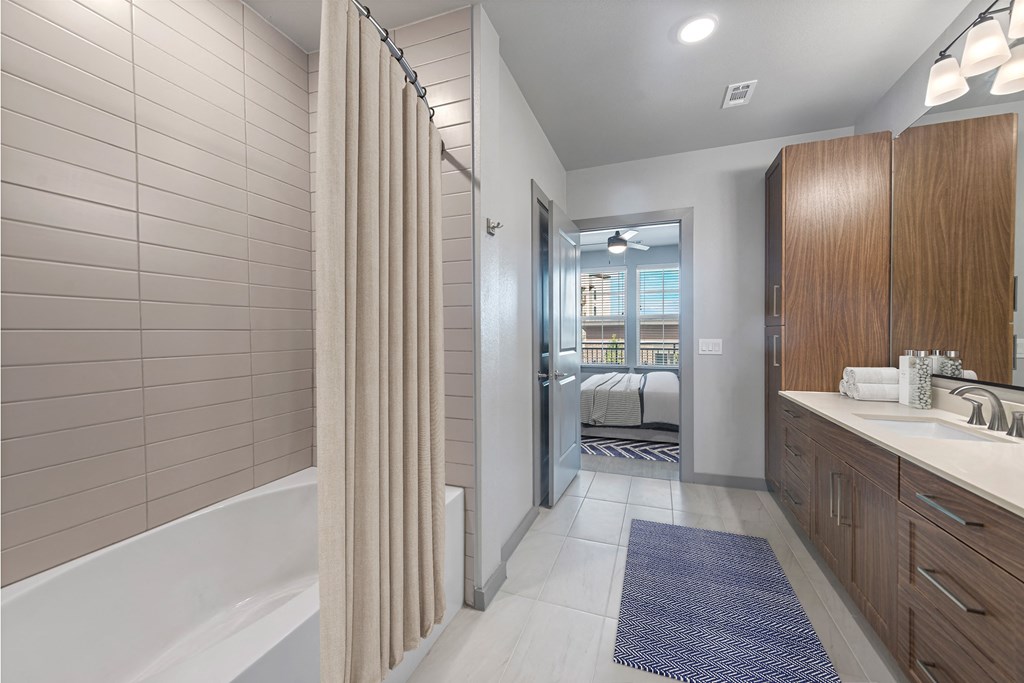 large bathroom with tub and cabinets