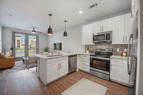 a kitchen with a stove top oven next to a sink