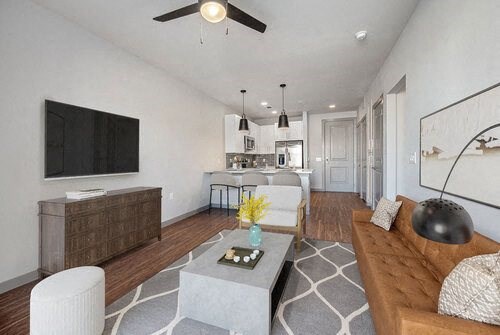a living room filled with furniture and a flat screen tv