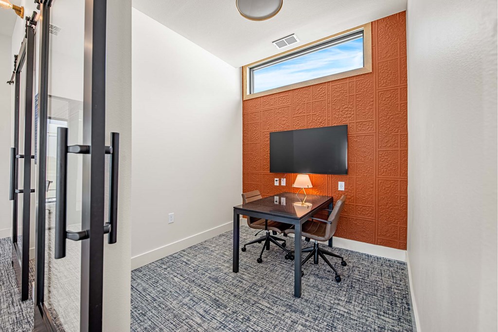 a room with a desk and a tv