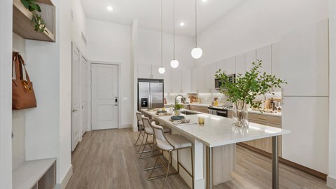 a kitchen with a large island and white cabinets