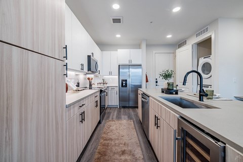 A modern kitchen with wooden cabinets and stainless steel appliances.