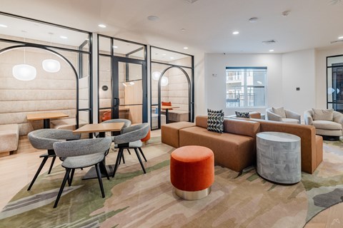 A modern living room with a grey sofa, a wooden table and a grey chair.