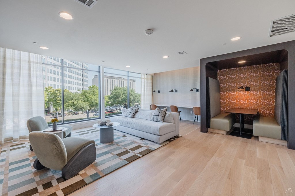 A modern living room with a large window and a fireplace.