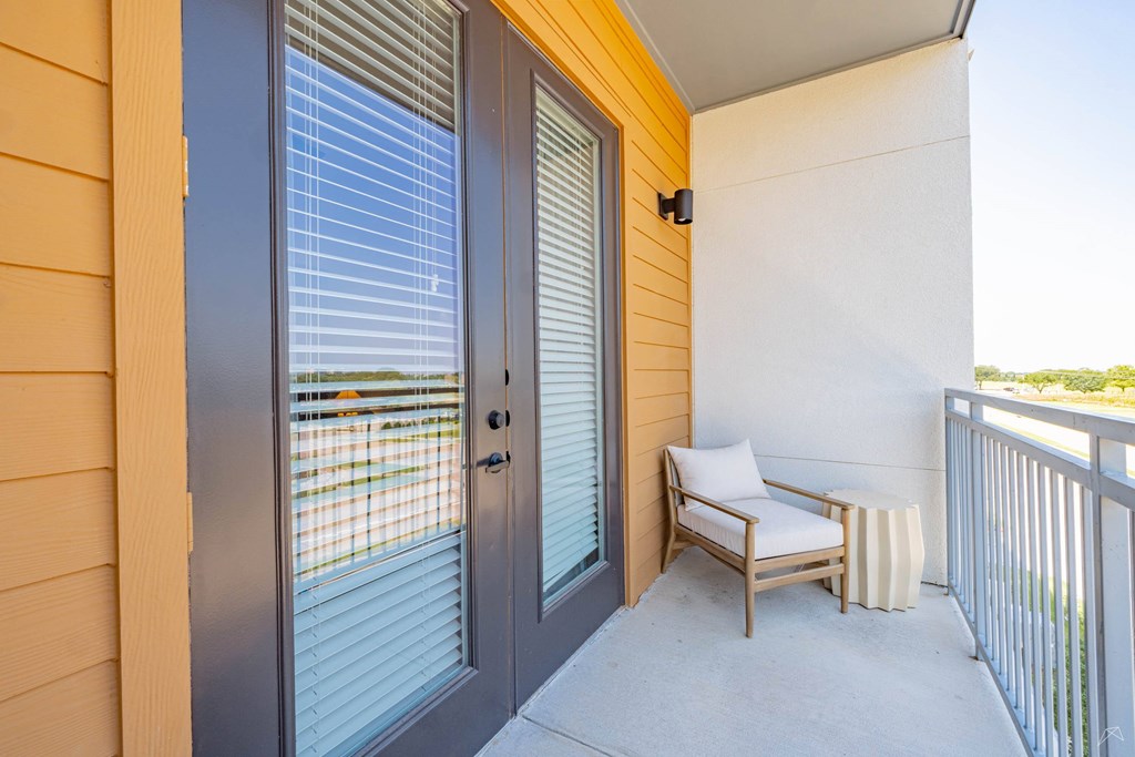 A patio with a chair and a table.
