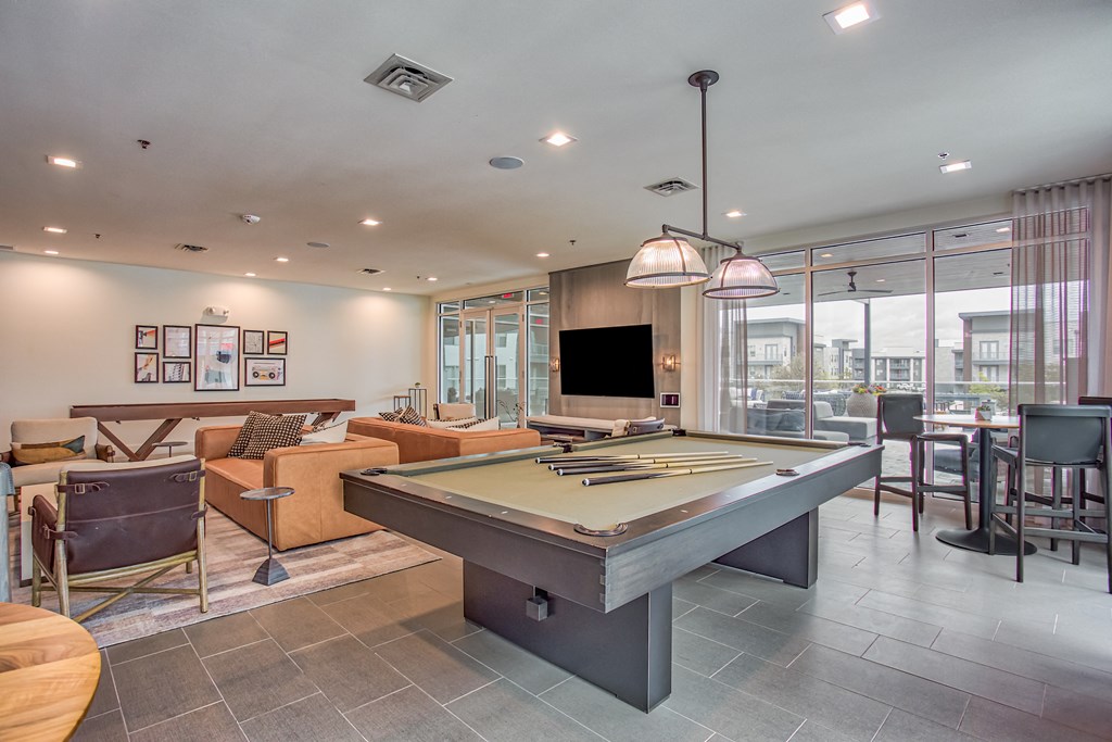 a games room with a pool table and a flat screen tv  at Presidium Revelstoke, Fort Worth