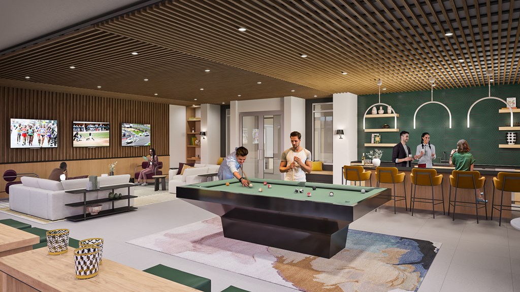 A group of people are gathered in a room with a pool table.