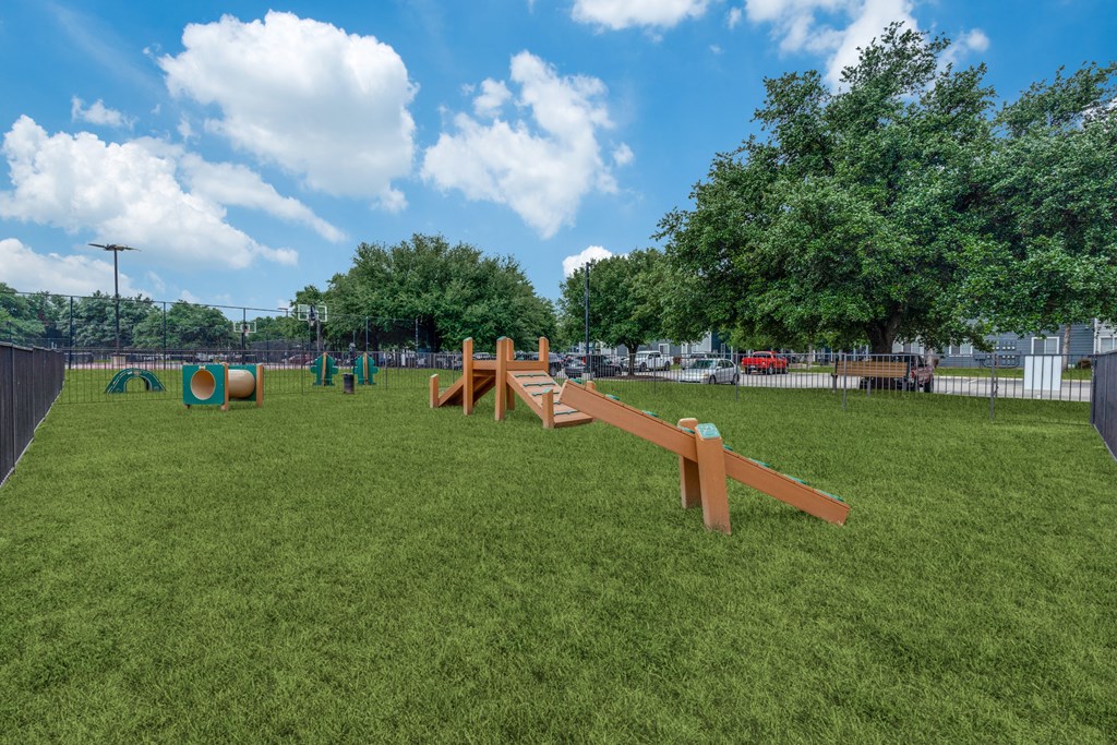 a park with a seesaw in the middle of the grass at Vibe on Riverside, Austin, TX, 78741