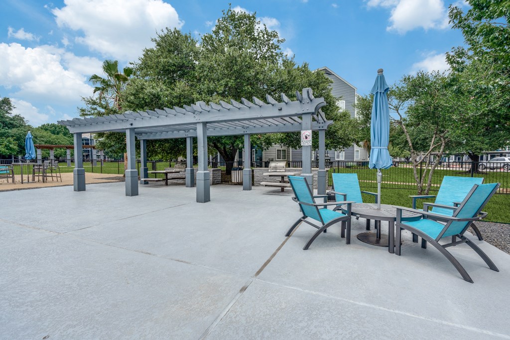 an outdoor patio with chairs and tables and a pavilion at Vibe on Riverside, Austin, TX, 78741