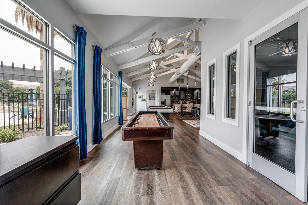 a pool table in the center of a room with glass doors at Vibe on Riverside, Austin, TX