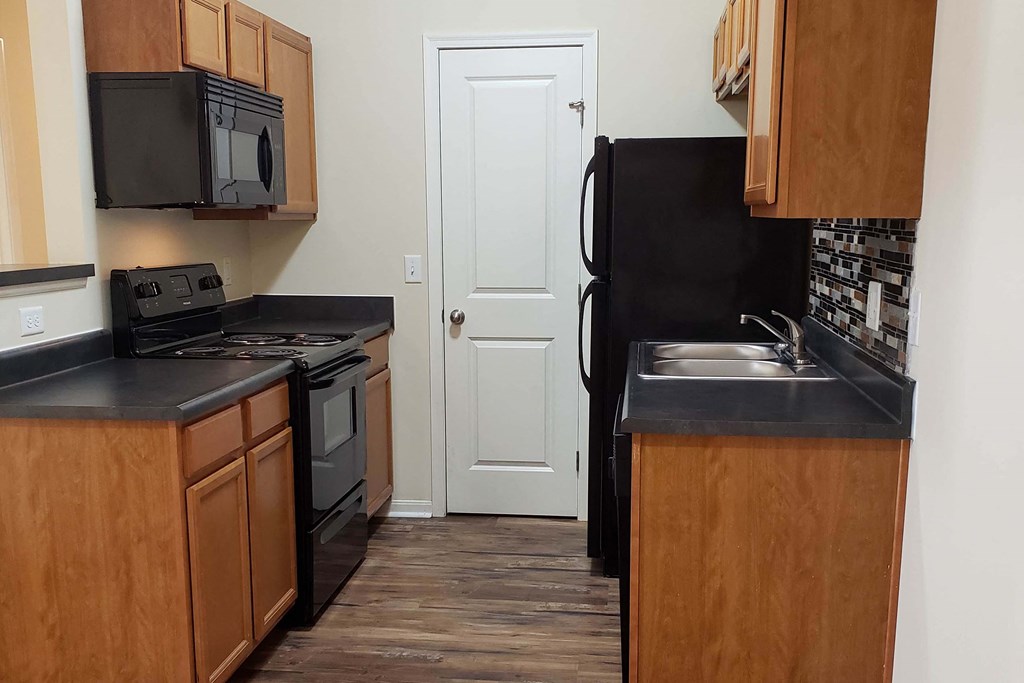 Wooden cabinets and black appliances at Residences at Northgate Crossing, Ohio