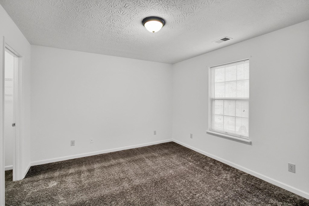 an empty living room with carpet and a window  at Aberdine Place, Georgetown, KY, 40324
