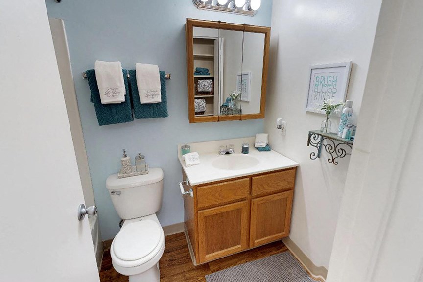a bathroom with a sink toilet and a mirror  at Hunter's Creek Apartments, Cincinnati, 45242