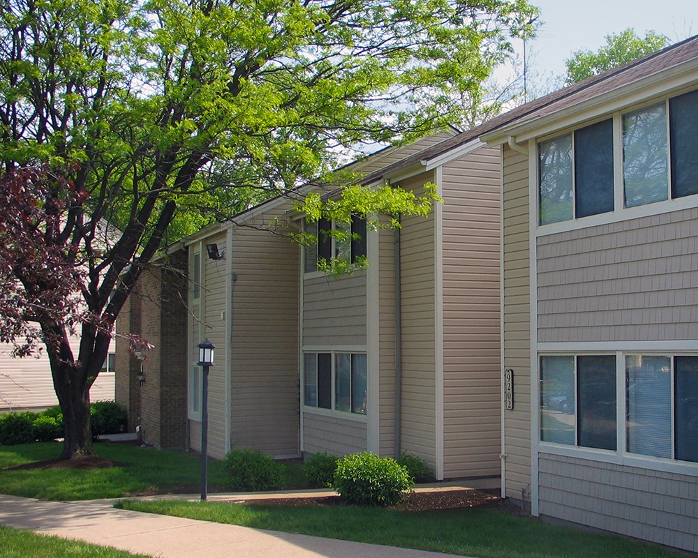a side view of an apartment building with a tree  at Hunter's Creek Apartments, Cincinnati
